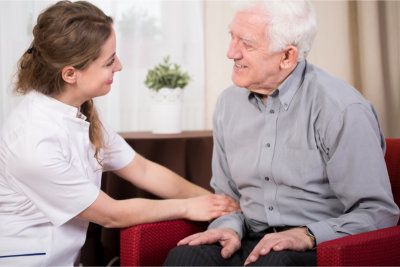 caregiver having conversation with elderly man